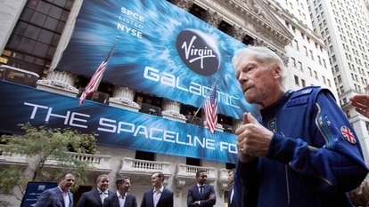 Richard Branson, right, founder of Virgin Galactic, and company executives gather for photos outside the New York Stock Exchange before his company's IPO. Branson announced Thursday, July 1, he plans to fly into space this month on the next test flight of his Virgin Galactic rocket ship. The launch window will open July 11. 