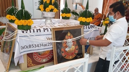 This handout courtesy of CryptoAmulets founder Ekkaphong Khemthong taken on June 9 shows a blessing ceremony for the digital amulets at the Wat Pattana Thammaram temple in Surin. 