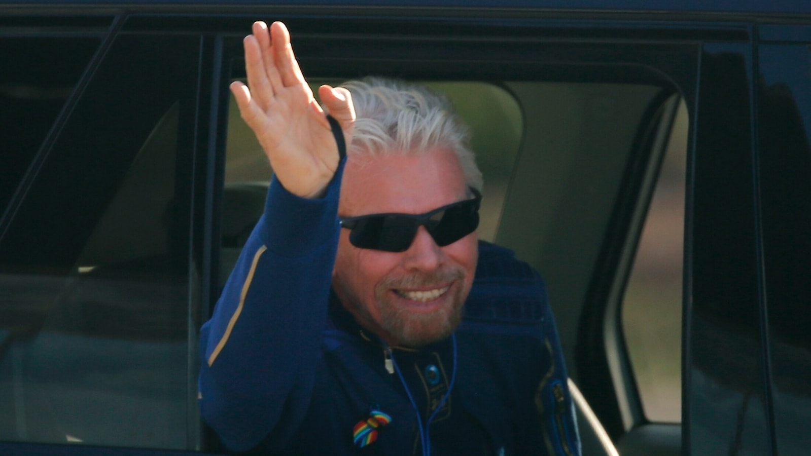 Billionaire entrepreneur Richard Branson departs with his crew prior to boarding, for travel to the edge of space in Virgin Galactic's passenger rocket plane VSS Unity, near Truth or Consequences, New Mexico, U.S., July 11, 2021. REUTERS/Joe Skipper