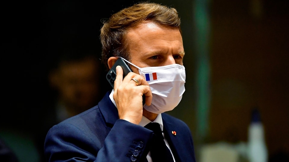 French President Emmanuel Macron speaks on his mobile phone during a round table meeting at an EU summit in Brussels. French newspaper Le Monde is reporting that the cellphones of French President Emmanuel Macron and 15 members of the French government in 2019 may have been among potential targets of surveillance by spyware made by the Israel-based NSO Group. 