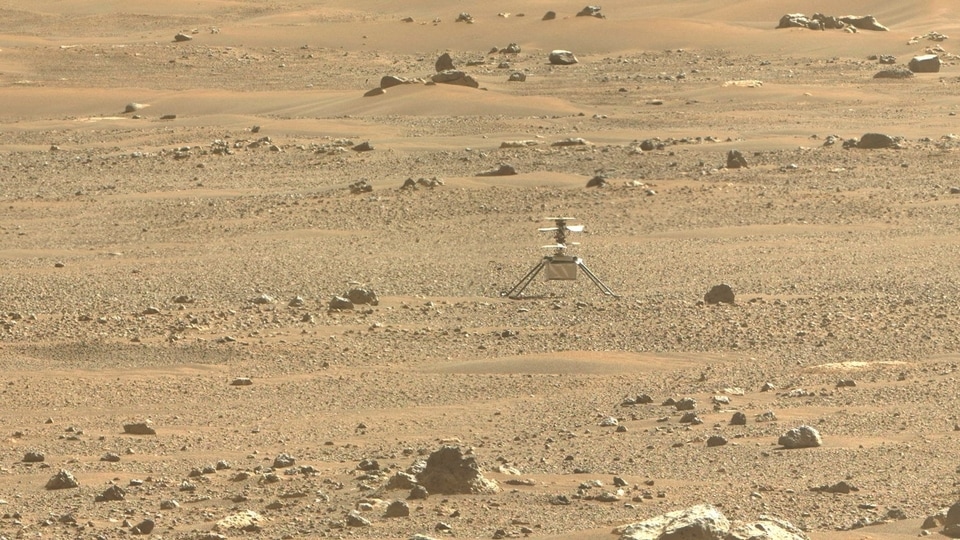 This NASA photo obtained June 30, 2021, 2021 shows NASA's Ingenuity Mars Helicopter(C) viewed using an image taken June 6, 2021 (the 105 the Martian day, or sol, of the mission), by the right Mastcam-Z cameras aboard NASA's Perseverance Mars rover. 