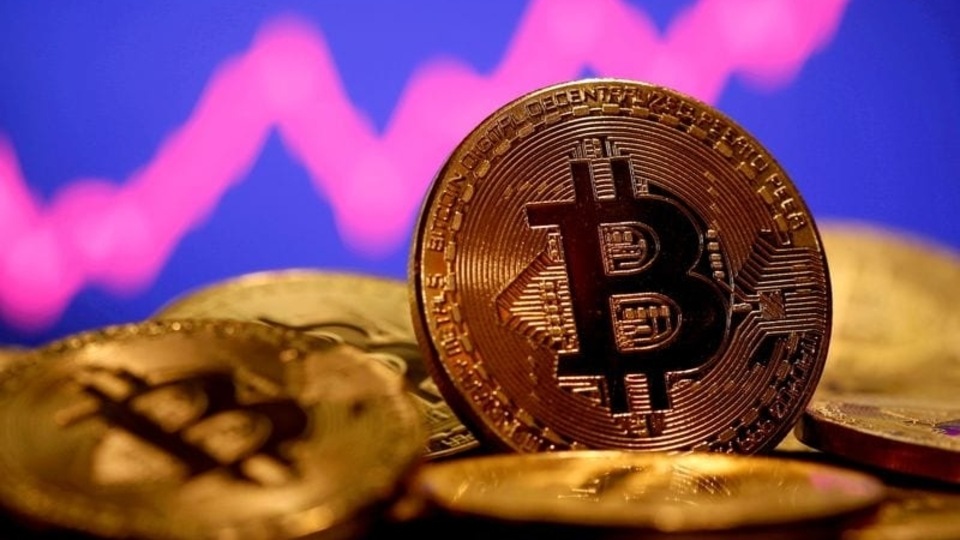FILE PHOTO: A representation of virtual currency Bitcoin is seen in front of a stock graph in this illustration taken January 8, 2021. 
