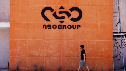 A man walks past the logo of Israeli cyber firm NSO Group at one of its branches in the Arava Desert, southern Israel July 22, 2021. 