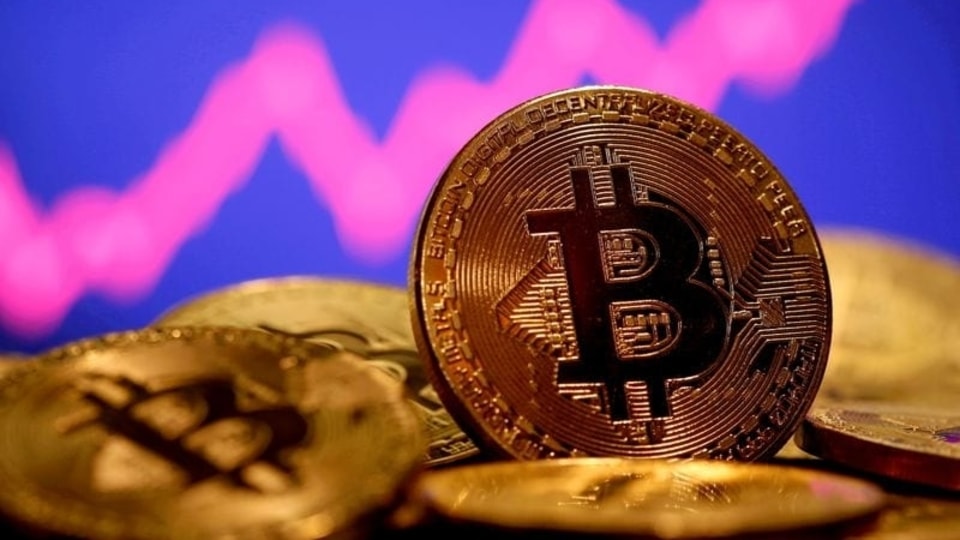 FILE PHOTO: A representation of virtual currency Bitcoin is seen in front of a stock graph in this illustration taken January 8, 2021. REUTERS/Dado Ruvic