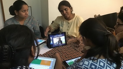 Akanksha Foundation's Paromita Sen taking in-person classes with her students with iPads in pre-pandemic times. 