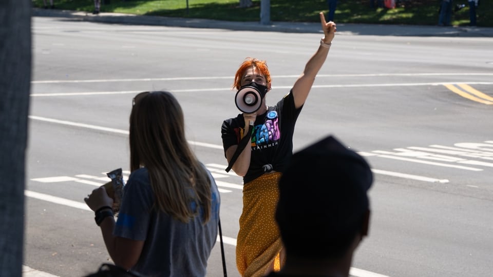 A protester with a megaphone addresses employees during a walkout at Activision Blizzard offices in Irvine, California, U.S., on Wednesday, July 28, 2021. Activision Blizzard Inc. employees called for the walkout on Wednesday to protest the company's responses to a recent sexual discrimination lawsuit and demanding more equitable treatment for underrepresented staff. Photographer: Bing Guan/Bloomberg
