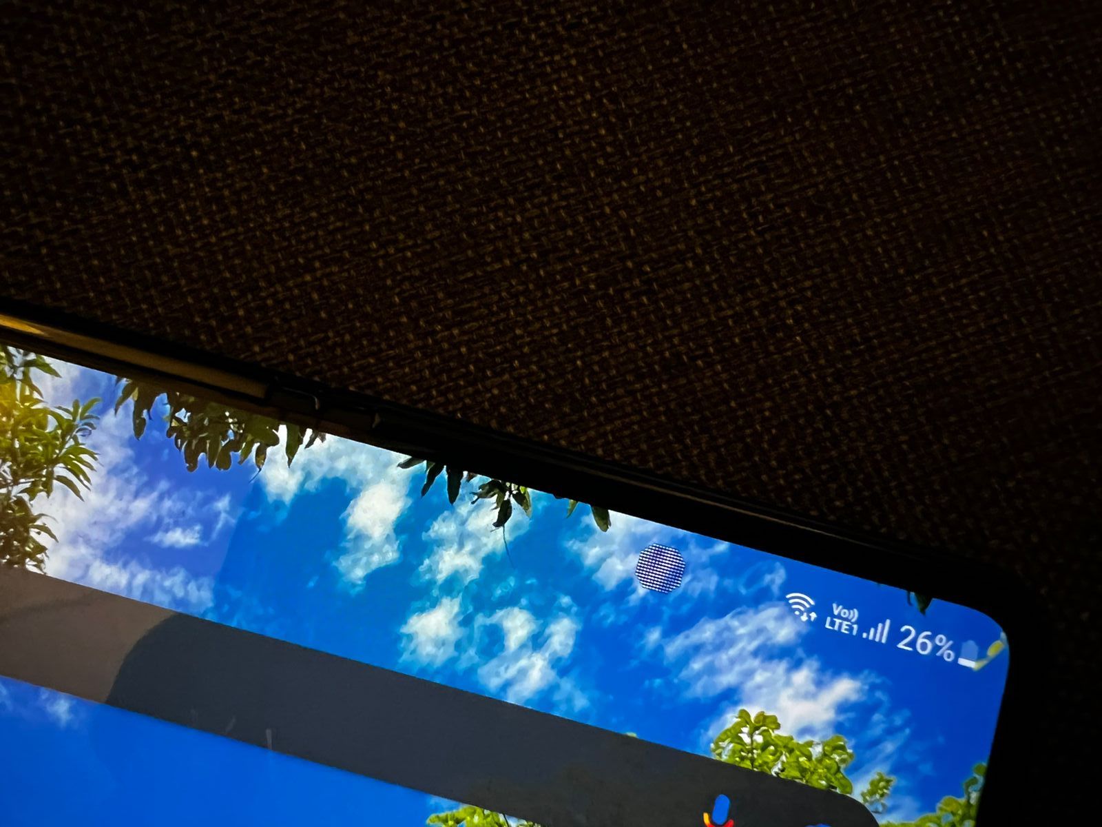 Samsung has “hidden” its selfie camera under the display. This 4MP camera is hidden by a screen door that looks like a smudge on the screen, like the screen glitched up in that little area.