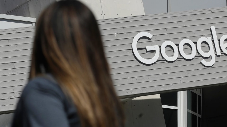 Google Pixel 6 and Google Pixel 6 Pro smartphones are rumoured to get four major OS updates and five years of security patches. (A woman walks below a Google sign on the campus in Mountain View, Calif.)
