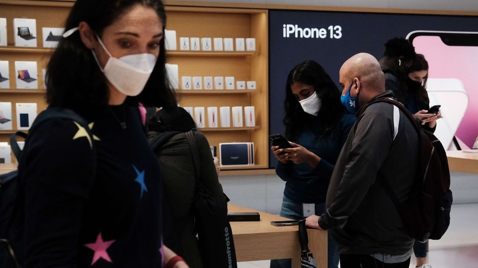 People shop at the Fifth Avenue Apple Store in New York City. The new phones come equipped with a A15 Bionic chip, improved dual-camera system and longer battery life than the iPhone 12. The iPhone 13 Mini starts at $729, and the iPhone 13 starts at $829. 