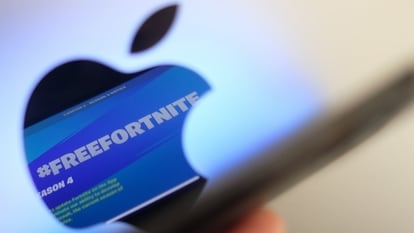 This file illustration photo shows the message #Freefortnite seen after the opening screen of Epic Games' Fortnite reflecting onto the Apple logo of the back of an I-mac in Los Angeles. Apple on October 8, 2021 appealed a federal judge's verdict in its legal battle with Fortnite-maker Epic Games over control of the App Store.