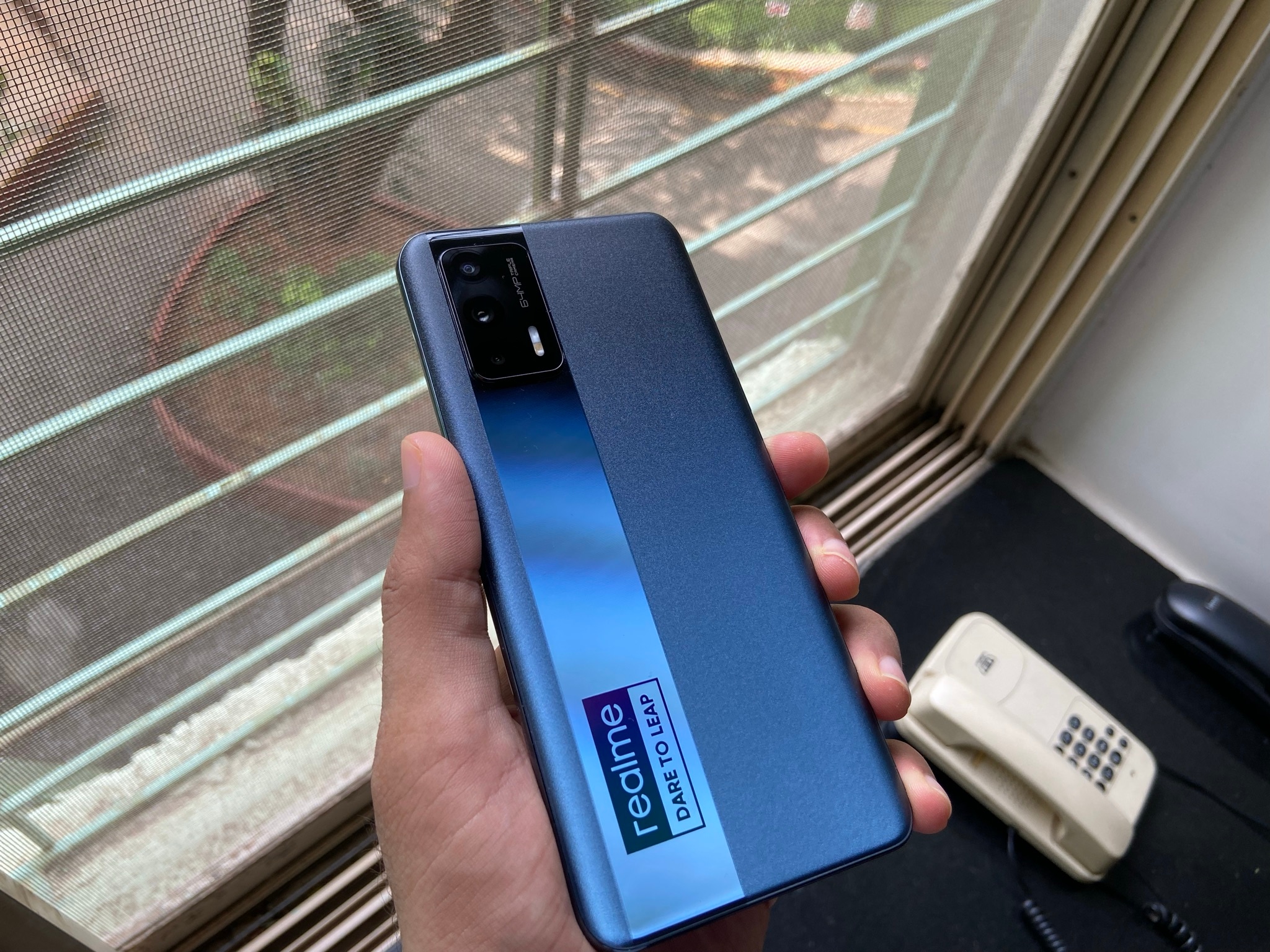 Realme X7 Max 5G Review: The‌ ‌'Dare to Leap' branding‌ ‌is‌ ‌still‌ ‌here,‌ ‌albeit‌ ‌in‌ ‌a‌ ‌much‌ ‌smaller‌ ‌size‌, on‌ ‌a‌ ‌left-aligned‌ ‌glossy‌ ‌strip‌ ‌that‌ ‌runs‌ ‌from‌ ‌the‌ ‌top‌ ‌to‌ ‌the‌ ‌bottom.‌