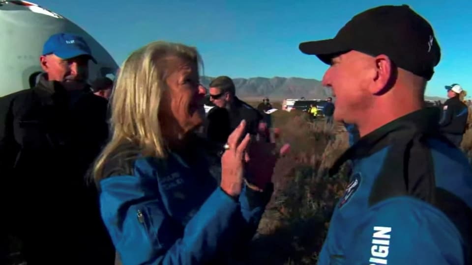 Jeff Bezos, speaks Laura Shepard Churchley, the daughter of the first American in space Alan Shepard and other crew of a Blue Origin New Shepard rocket after their return to Launch Site One in west Texas.