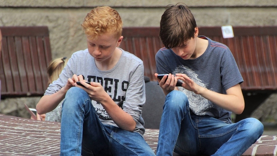Kids playing mobile games