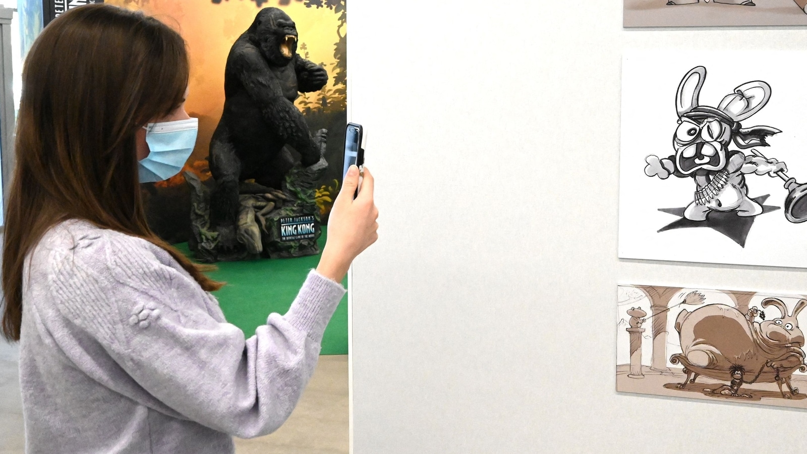 A visitor takes photos of the new exhibition dedicated to the French edition and distribution brand of video games Ubisoft, at the Cite Creative, in Montpellier. Assassin's Creed
