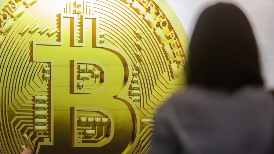 An advertisement displays a Bitcoin cryptocurrency token at a subway station in Hong Kong, China, on Thursday, Feb. 10, 2022. Employees all over the world are opting to get paid in cryptocurrencies, though they're still in a small minority, according to global payrolls and hiring company Deel.�Photographer: Paul Yeung/Bloomberg