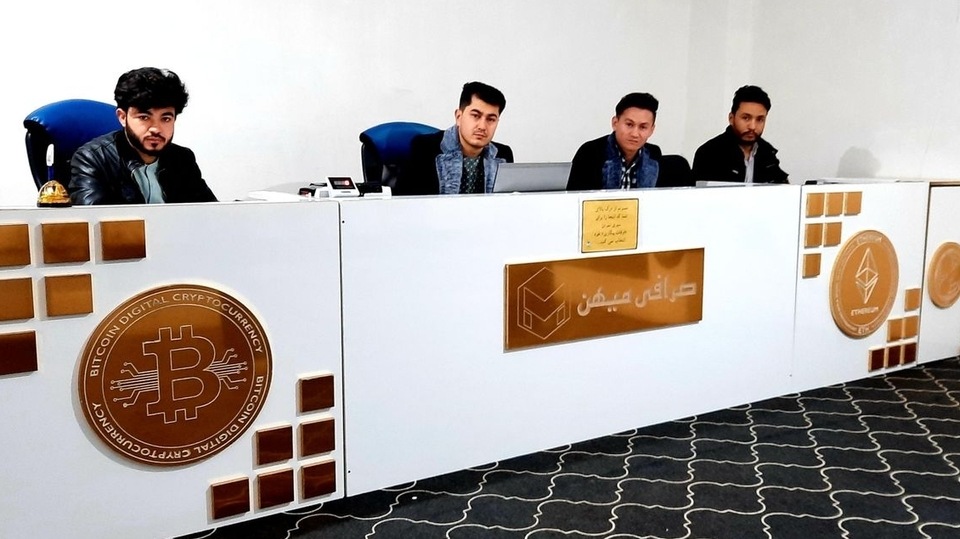 In a white-walled office, Habibullah Timori and his four employees are making trades for customers, using their Samsung phones. Cryptocurrency