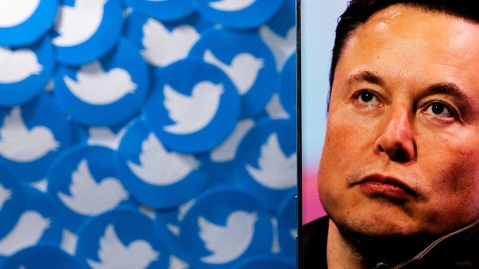 FILE PHOTO: An image of Elon Musk is seen on a smartphone placed on printed Twitter logos in this picture illustration taken April 28, 2022. REUTERS/Dado Ruvic/Illustration