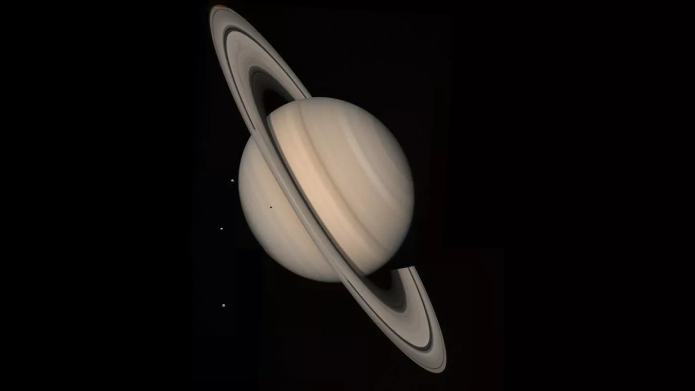 Voyager spacecraft captured this mesmerizing image of Saturn and three of its moons - Tethys, Dione and Rhea. The image was captured on August 4, 1982 at a distance of 13 million miles from Saturn. Voyager 1