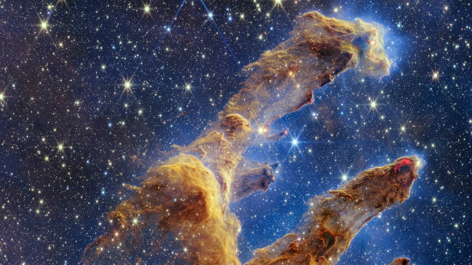 NASA의 웹 망원경은 창조 기둥의 별 가득 찬 이미지를 촬영합니다.