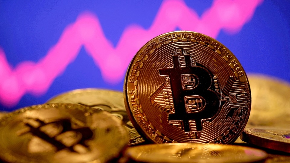 FILE PHOTO: A representation of virtual currency Bitcoin is seen in front of a stock graph in this illustration taken January 8, 2021. REUTERS/Dado Ruvic//File Photo