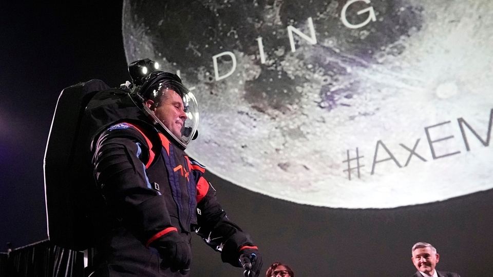 Axiom Space chief engineer Jim Stein demonstrates a prototype spacesuit, Wednesday, March 15, 2023, in Houston. NASA selected Axiom Space to design the spacesuits that its moonwalking astronauts will wear when they step onto the lunar surface later this decade. (AP Photo/David J. Phillip)