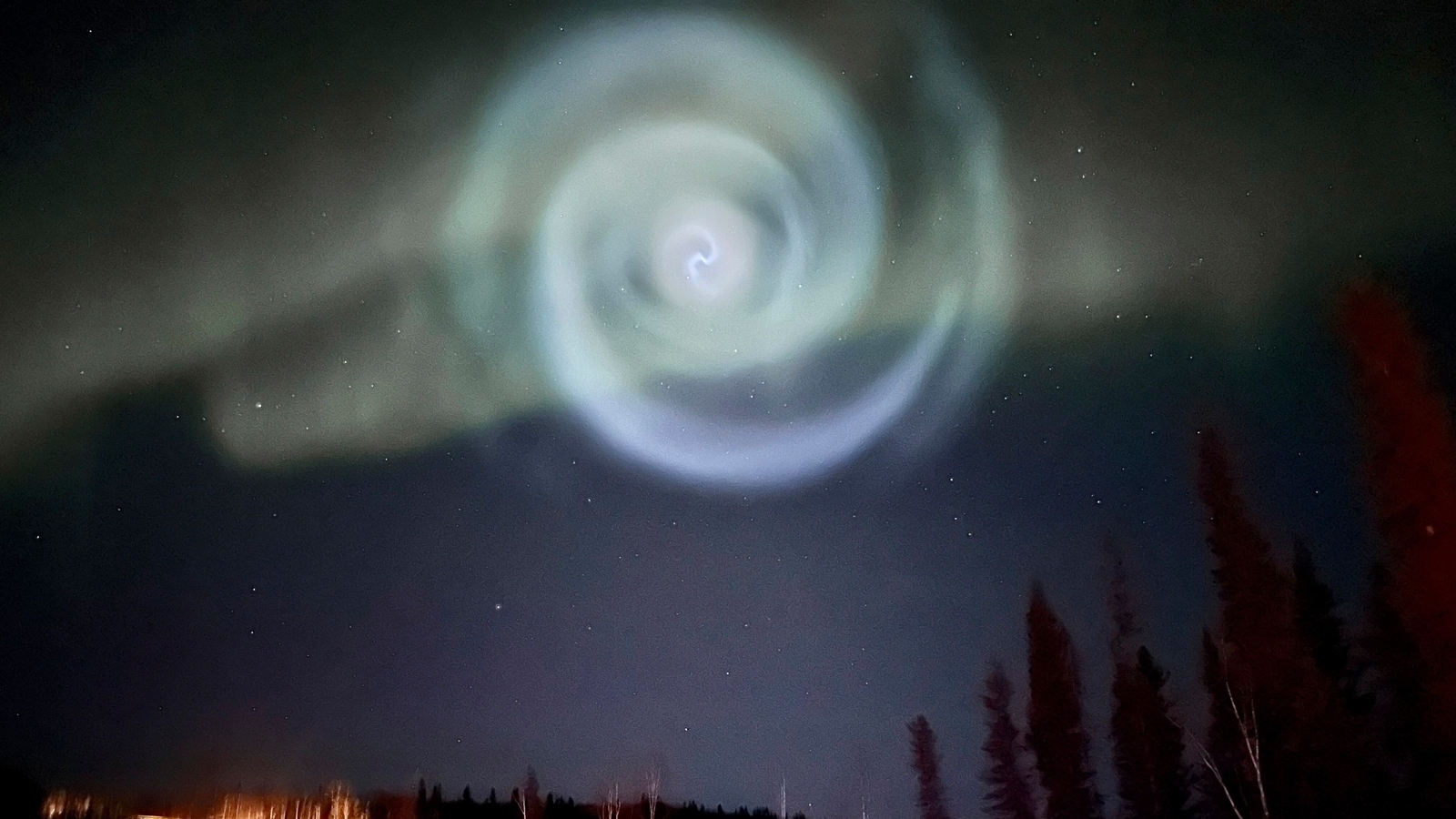 A light baby blue spiral was formed when excess fuel that had been released from a SpaceX rocket turned to ice and then water vapor reflected the sunlight in the upper atmosphere. (Christopher Hayden via AP) SpaceX