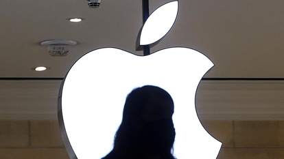 FILE PHOTO: A person is silhouetted against a logo sign of the Apple Store in the Grand Central Terminal in the Manhattan borough of New York City, New York, U.S., January 4, 2022.  REUTERS/Carlo Allegri/File Photo