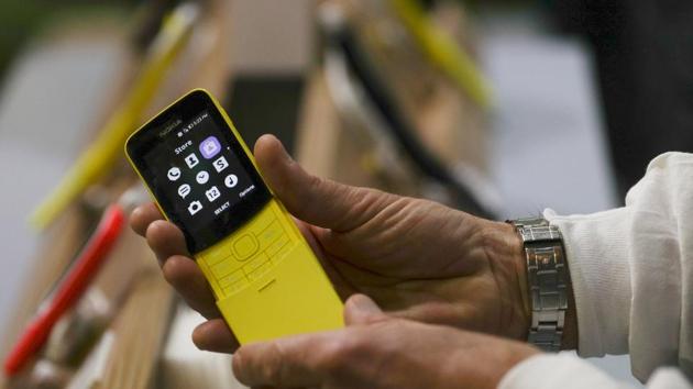 A man holds a Nokia 8110 4G device at the Mobile World Congress in Barcelona, Spain, February 28, 2018.
