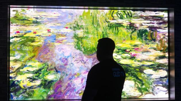 A visitor to Samsung's First Look event watches a 146-inch (3.7 meter) TV called 