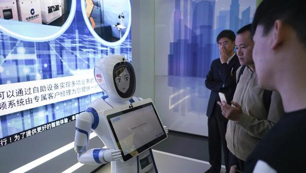 Bank customers speak with a robot at an automated branch in Shanghai.