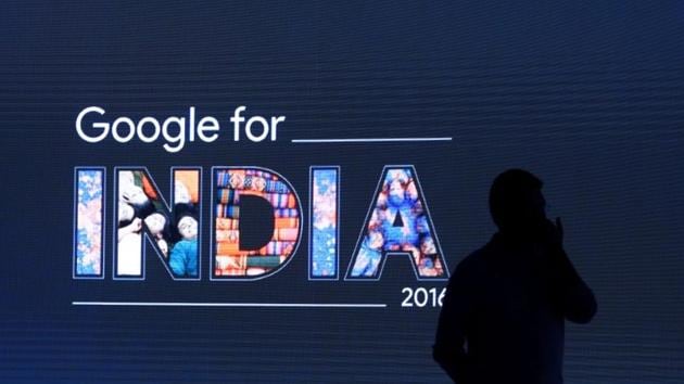 A man stands in front of a screen during a Google event in New Delhi.