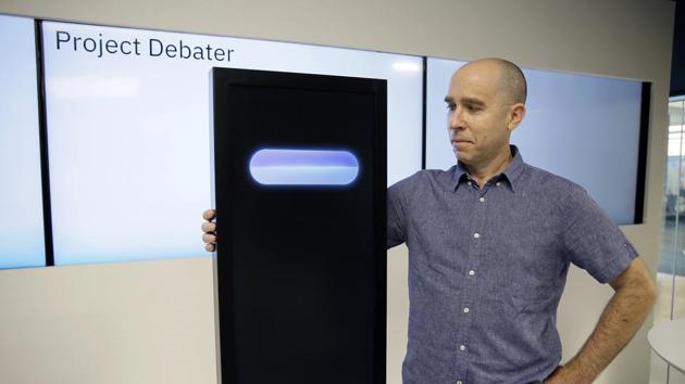 Dr. Noam Slonim, principal investigator, stands with the IBM Project Debater before a debate between the computer and two human debaters Monday, June 18, 2018, in San Francisco.