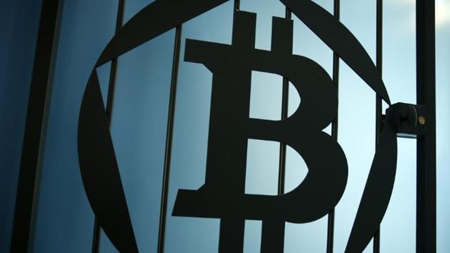 FILE PHOTO: A Bitcoin (virtual currency) logo is pictured on a door in an illustration picture taken at La Maison du Bitcoin in Paris May 27, 2015. REUTERS/Benoit Tessier