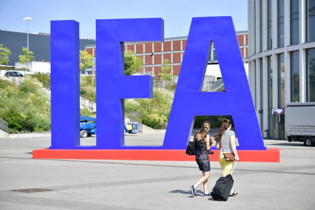 Women pass by an IFA logo at the entrance of the upcoming IFA, the world's leading trade show for consumer electronics and home appliances, in Berlin on August 29, 2018.