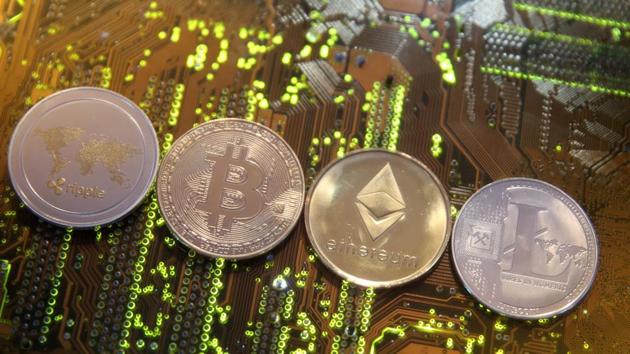 FILE PHOTO: Representations of the Ripple, Bitcoin, Etherum and Litecoin virtual currencies are seen on a PC motherboard in this illustration picture, Picture is taken February 13, 2018. REUTERS/Dado Ruvic/Illustration/File Photo