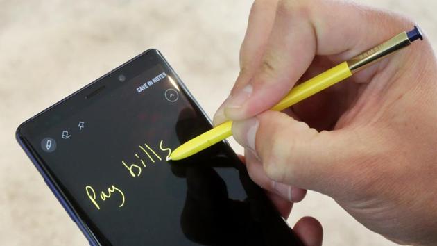 In this Aug. 7, 2018, file photo the Samsung Galaxy Note 9 and stylus are shown in New York. The stylus now acts as a remote control for triggering the camera shutter or pausing and forwarding songs.