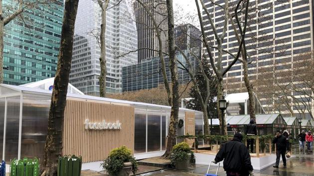 People walk by a Facebook “pop-up” trailer in New York’s Bryan Park on Thursday, Dec. 13, 2018. The company hosted a one-day event open to the public, with Facebook employees on hand to answer questions about privacy settings and other issues. The pop-up event caps a difficult year for the company.