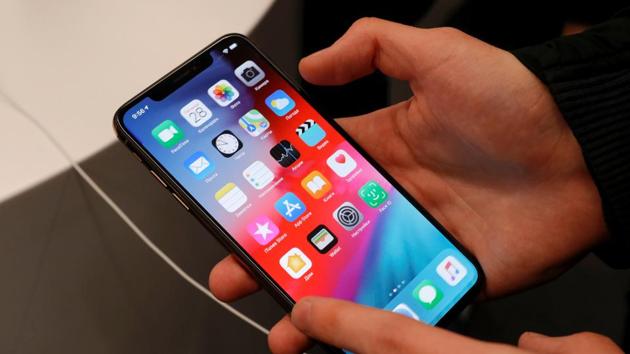 FILE PHOTO: A customer tests a smartphone during the launch of the new iPhone XS and XS Max sales at 