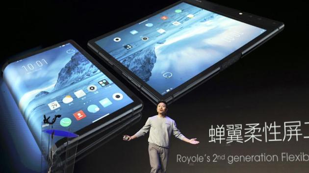 In this Wednesday, Oct. 31, 2018, photo, Royole Corporation founder and CEO Bill Liu unveils what is described as the world's first commercial foldable smartphone called the Royole FlexPai.