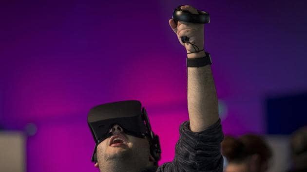 An attendee uses the Oculus VR Inc. Rift virtual reality (VR) headset and controllers during the Oculus Connect 5 product launch event in San Jose, California, U.S., on Wednesday, Sept. 26, 2018. Facebook Inc. unveiled a wireless virtual-reality headset called Oculus Quest, an attempt to help popularize the developing technology with a more mainstream audience.