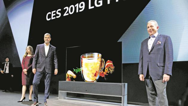 David Vanderwaal (L), senior vice president of marketing for LG Electronics USA, and Tim Alessi, senior director of home entertainment products for LG Electronics USA, stand by an LG Signature OLED TV R, a television with a rollable screen that can be retracted into its base, during an LG Electronics news conference at the 2019 CES in Las Vegas, Nevada, U.S. January 7, 2019.