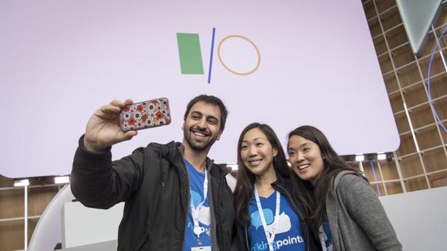 An attendees uses a smartphone to take a selfie photograph during the Google I/O Developers Conference in Mountain View, California, U.S., on Tuesday, May 7, 2019. Each year, Google pitches new ways its trove of user data can improve apps, websites and other services on smartphones. This year, the internet giant will try to convince the world it's a responsible steward of all that information. Photographer: David Paul Morris/Bloomberg