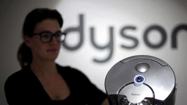 A Dyson employee shows a Dyson 360 Eye robot vacuum cleaner during the IFA Electronics show in Berlin.