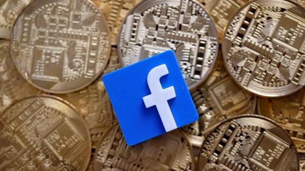 A 3D printed Facebook logo is seen on representations of the Bitcoin virtual currency in this illustration picture, June 18, 2019.