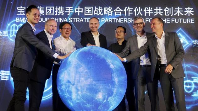 Jochen Goller (2nd L), head of BMW's China operations, and other executives attend an event announcing the German automaker's partnership with China's Tencent Holdings in launching a computing center for self-driving vehicles, in Beijing, China July 19, 2019.