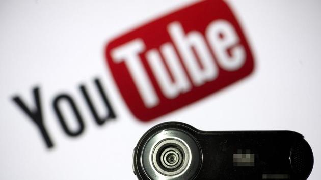 In this file photo taken on June 28, 2013 a webcam is positioned in front of YouTube's logo in Paris. - Millions of children regularly use YouTube to watch video game tutorials, television shows and even to watch random people unbox new toys. But consumer and child protection groups are worried that the Google-owned video service is collecting data on young users at the same time, and failing to shield them from inappropriate content.These organizations argue that Google needs to make big changes, including putting all child-directed videos in its separate YouTube Kids app to comply with laws in the United States and elsewhere.