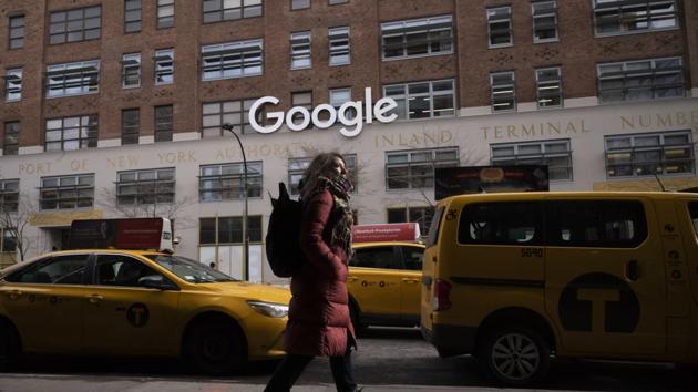 FILE - In this Dec. 17, 2018, file photo a woman walks past Google offices in New York. Alphabet Inc., parent company of Google, reports financial earnings on Thursday, July 25, 2019. (AP Photo/Mark Lennihan, File)