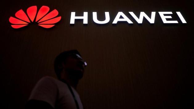 A man walks past a sign board of Huawei at CES (Consumer Electronics Show) Asia 2018 in Shanghai, China June 14, 2018.