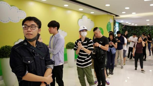 Customers wait outside an Apple Store before Apple's new iPhone 11, 11 Pro and 11 Pro Max go on sale in Beijing, China, September 20, 2019.
