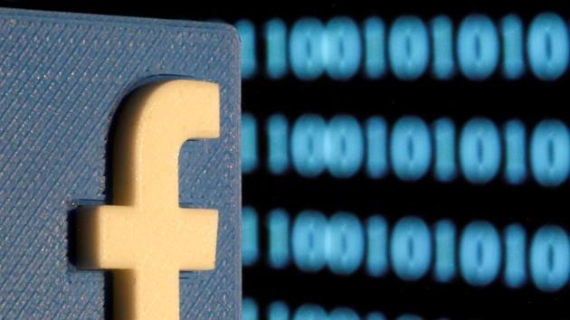 FILE PHOTO: A 3-D printed Facebook logo is seen in front of displayed binary code in this illustration picture, June 18, 2019. REUTERS/Dado Ruvic/File Photo